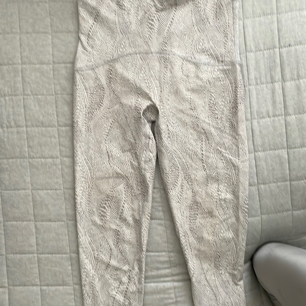 Spanx Booty Boost leggings silver and white.
